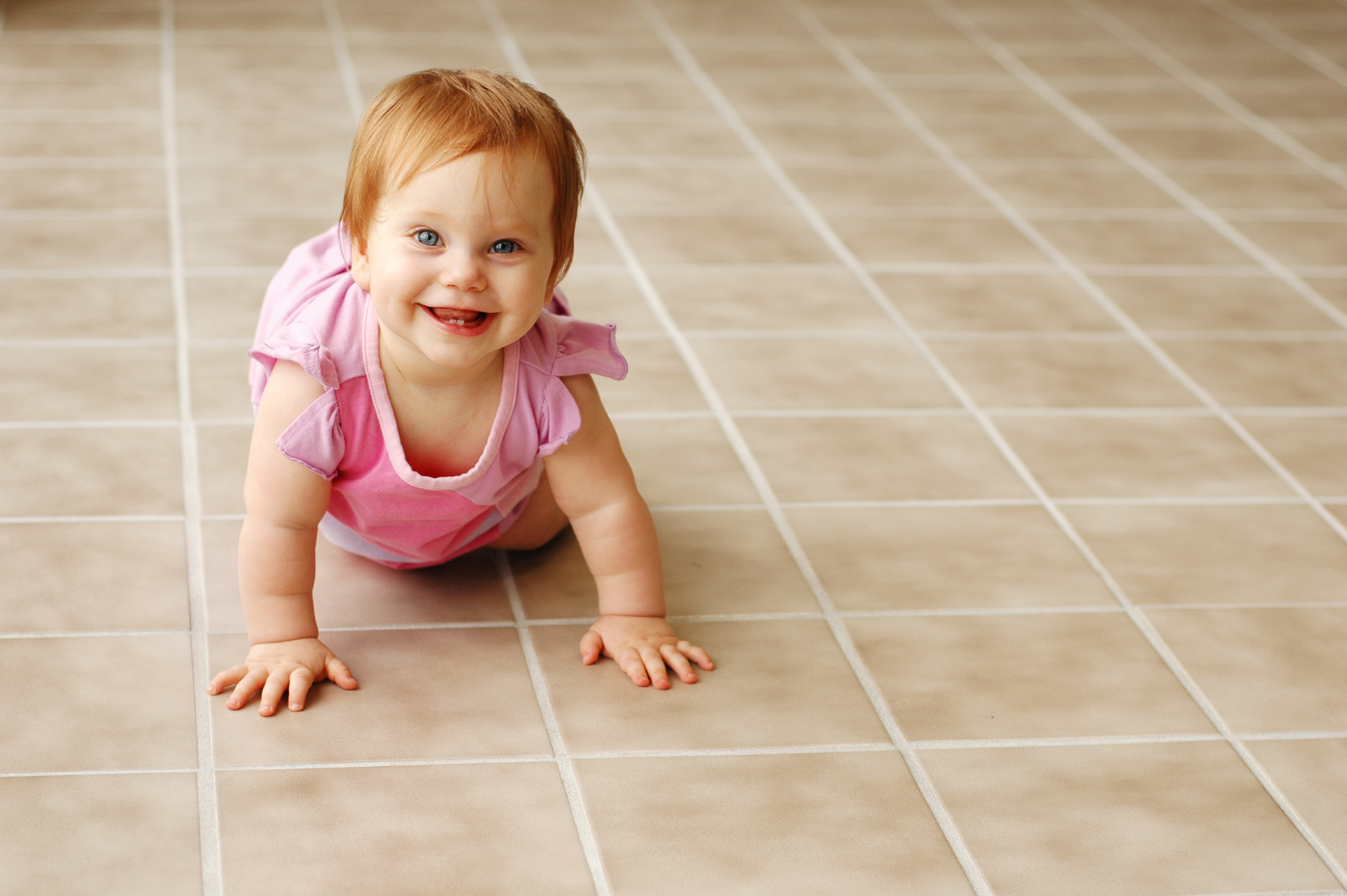 Baby crawling on recently cleaned tile and grout in Port St. Lucie